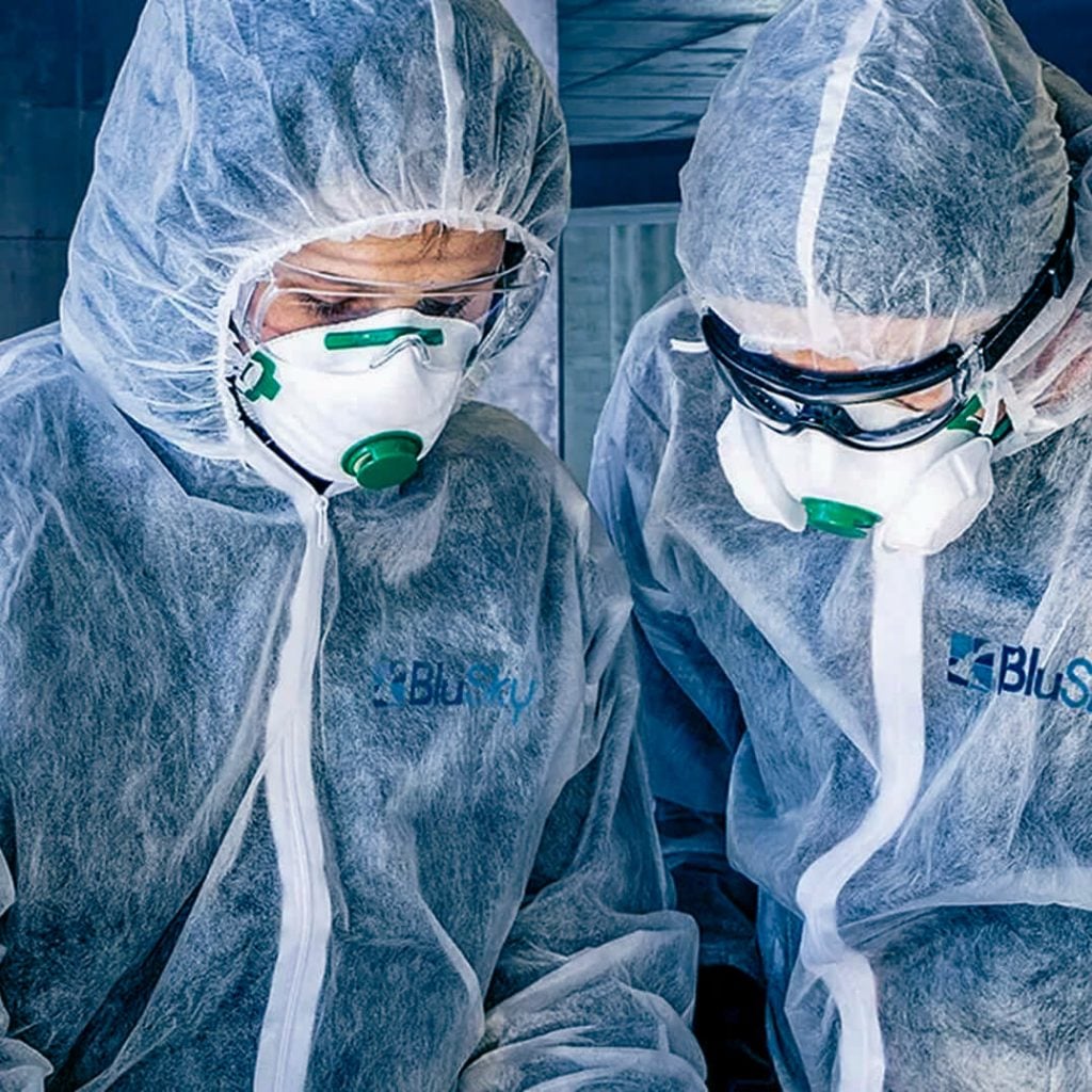 BluSky staff members in protective gear inspecting mold infection in home