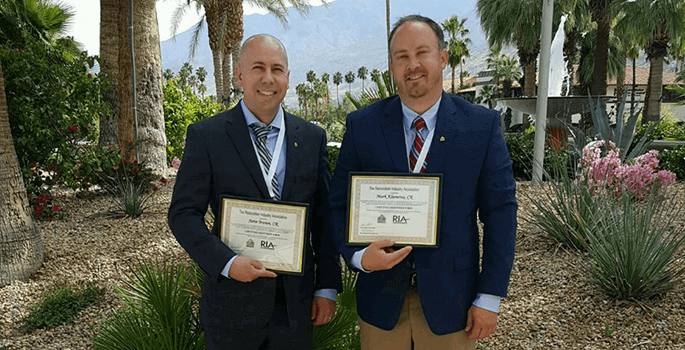 BluSky employees obtain Certified Restorer certification and smiling for portrait