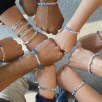 multiple people wearing "BluSky" bracelets