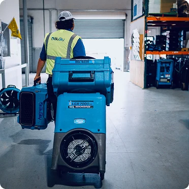 BluSky staff member carrying restoration equipment