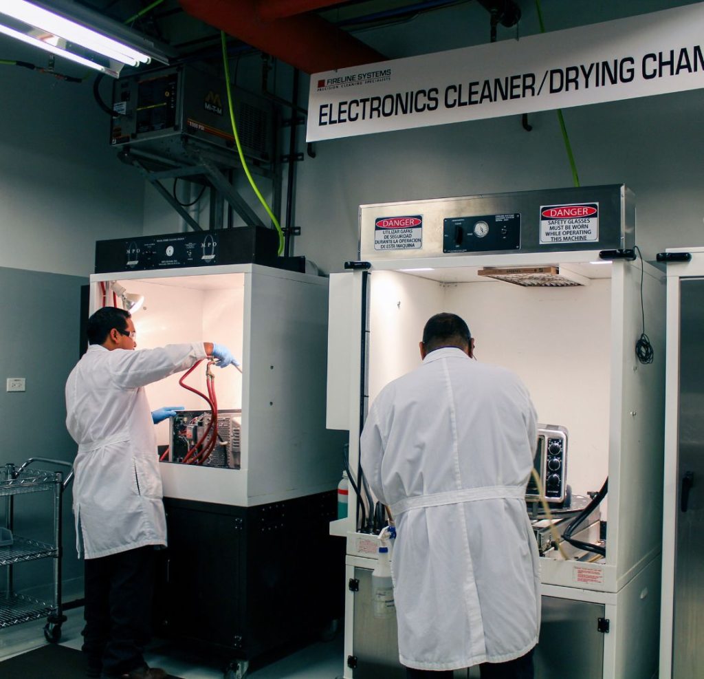 restoration company cleaning and drying electronics inside chamber