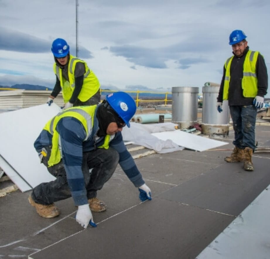 three blusky members working on roof