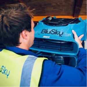 man in BluSky work attire handling content cleaning equipment