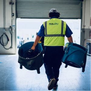 BluSky staff member carrying water damage equipment