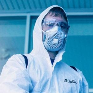 BluSky staff member in protective mask and gown