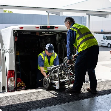 restoration workers loading equipment into truck