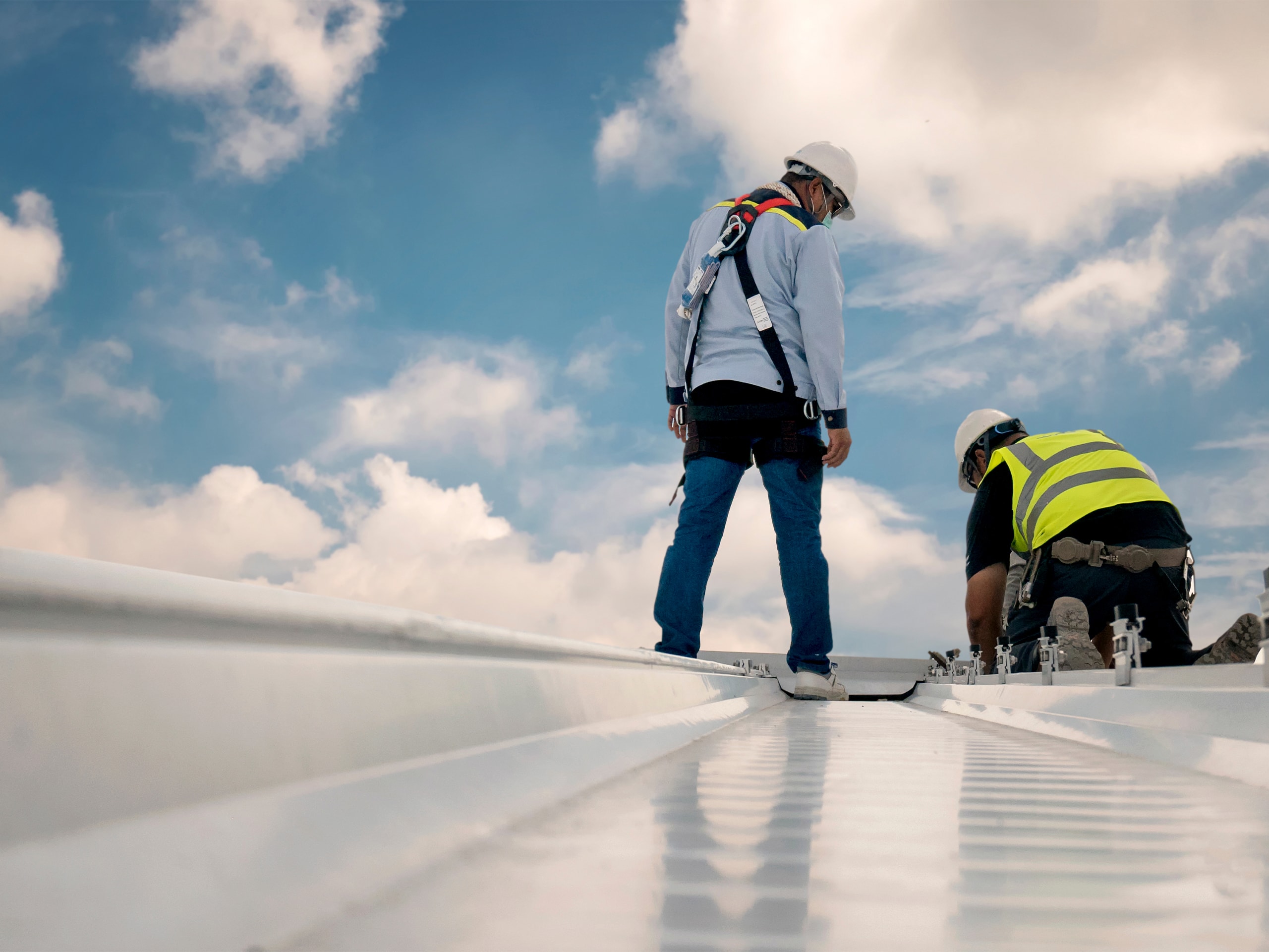 inspector inspecting new roof on commercial building