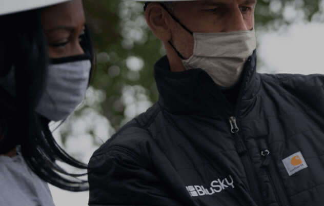 two blusky employees wearing masks close-up