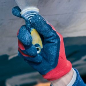 man scraping wallpaper