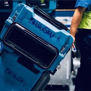 man pulling machinery with BluSky label