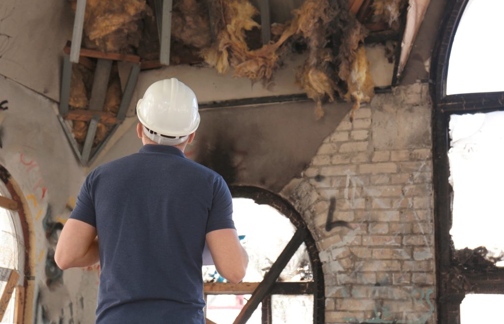 blusky employee inspecting fire damage