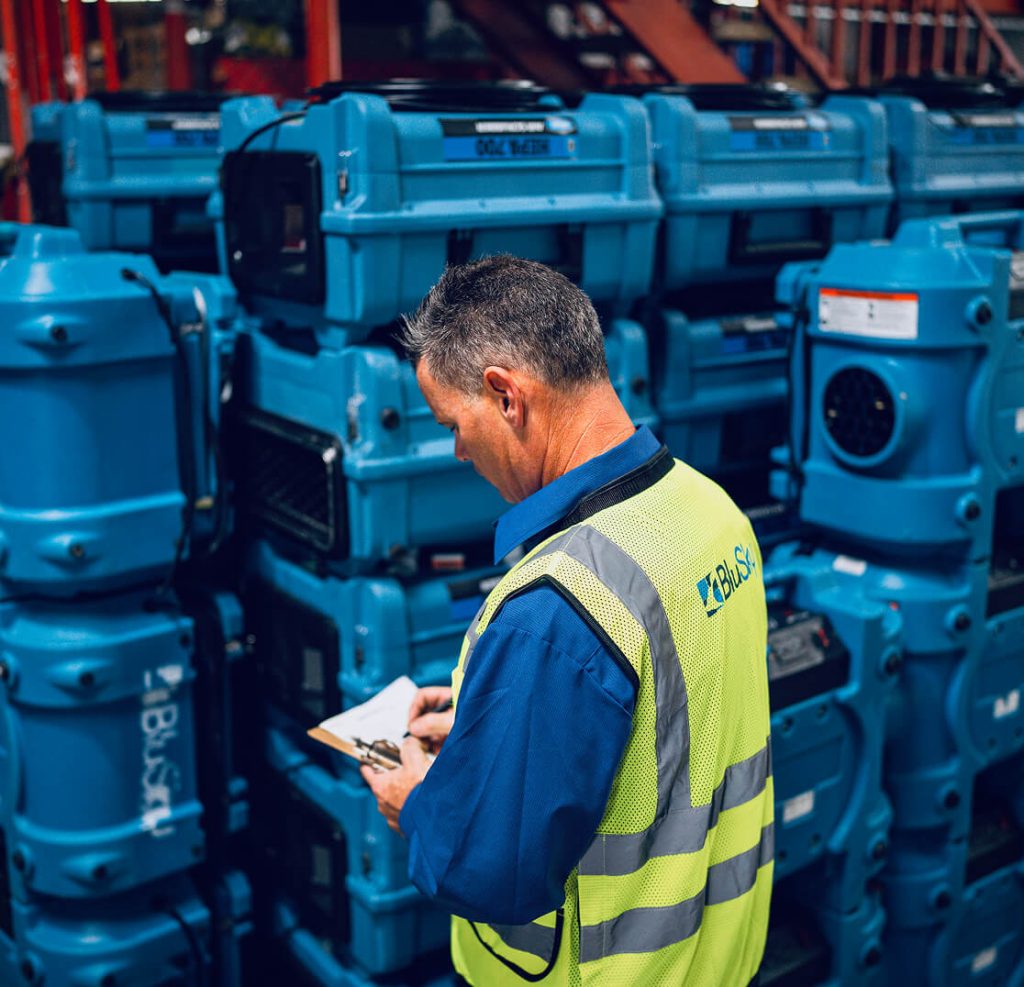 man in BluSky vest filling out paperwork